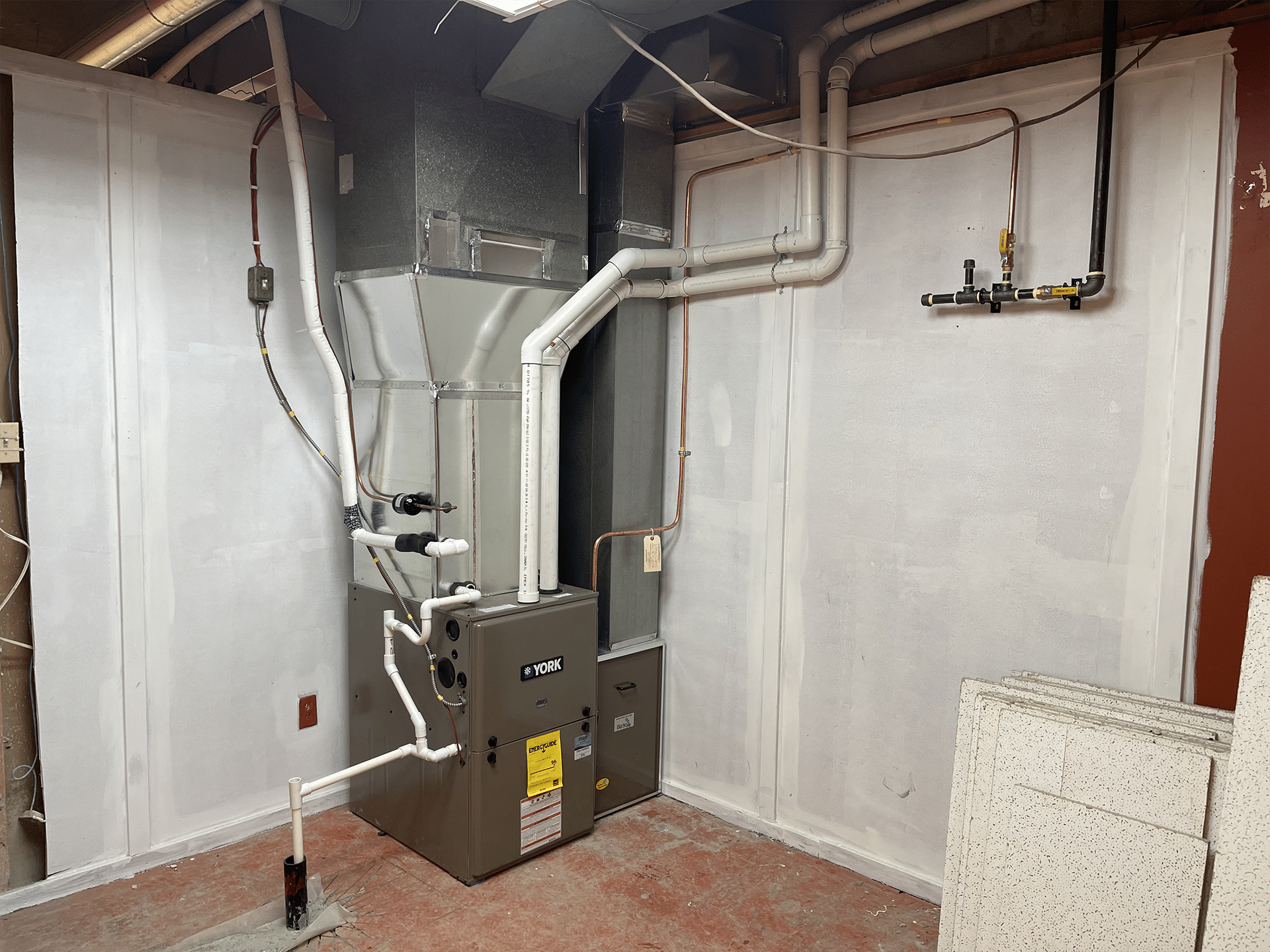 York AC system room featuring HVAC equipment and control panels in a well-lit, organized space.