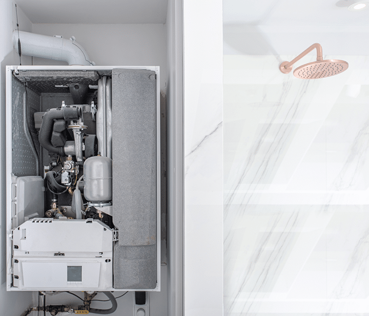 A white bathroom featuring a shower and a wall-mounted white water heater system.