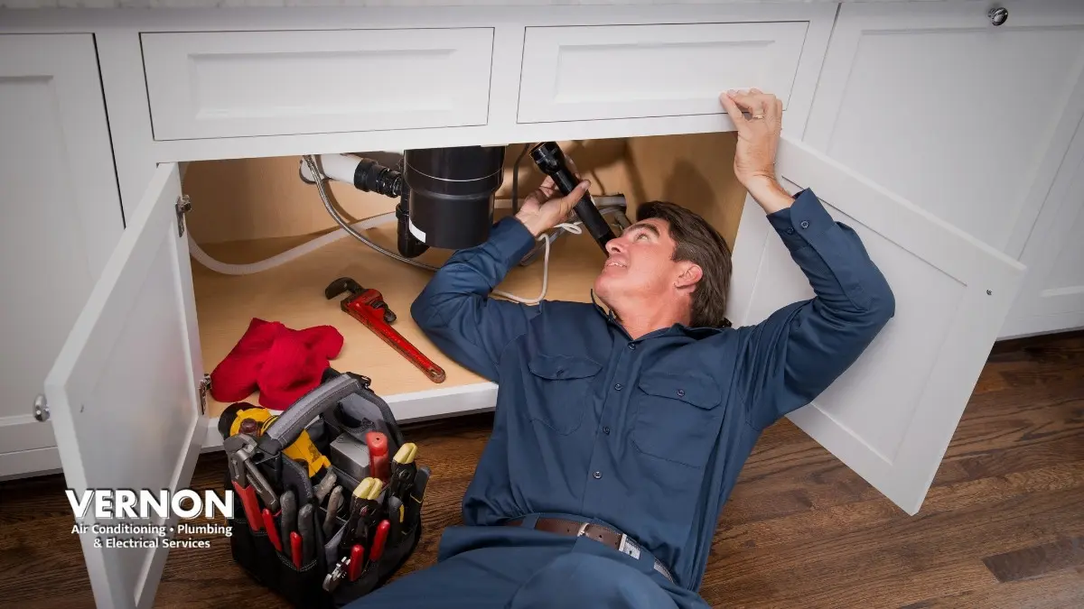 plumber conducting regular plumbing maintenance in British Columbia