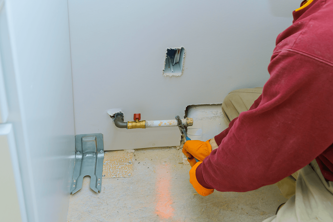 A man in a red shirt stands in a kitchen designed for natural gas cooking.