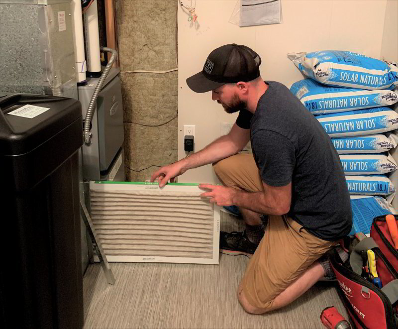 Phyxter HVAC technician changing a furnace filter