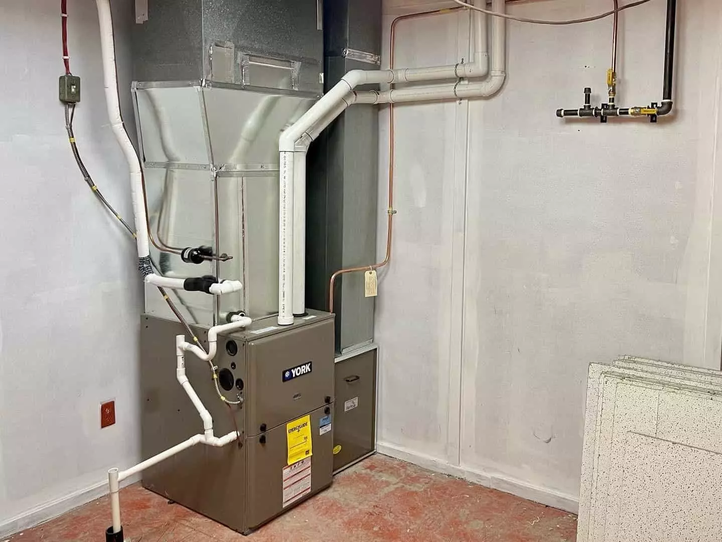 York AC furnace room featuring HVAC equipment and control panels in a well-lit, organized space.