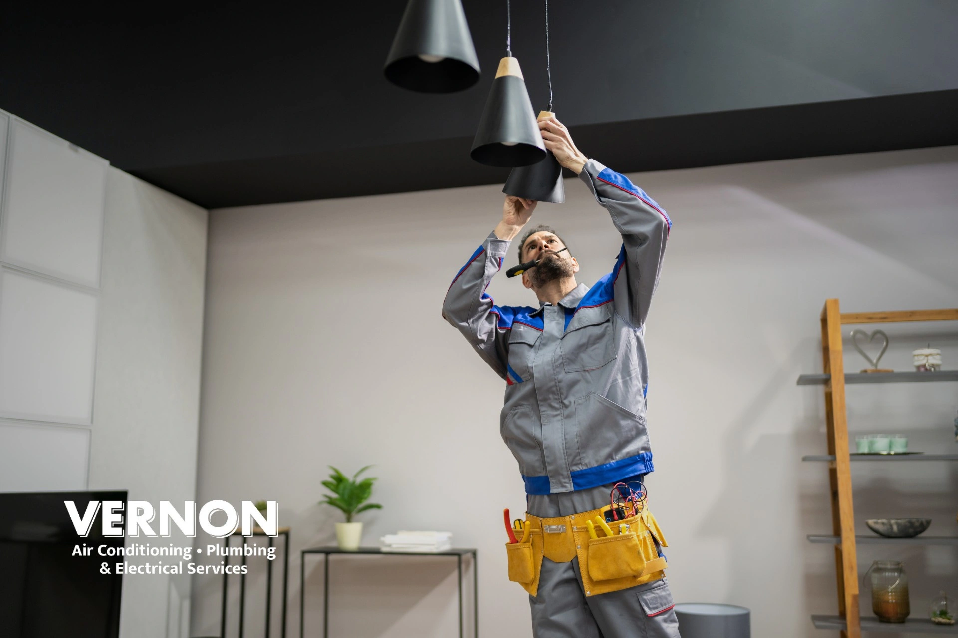 BC electrician working on a light socket