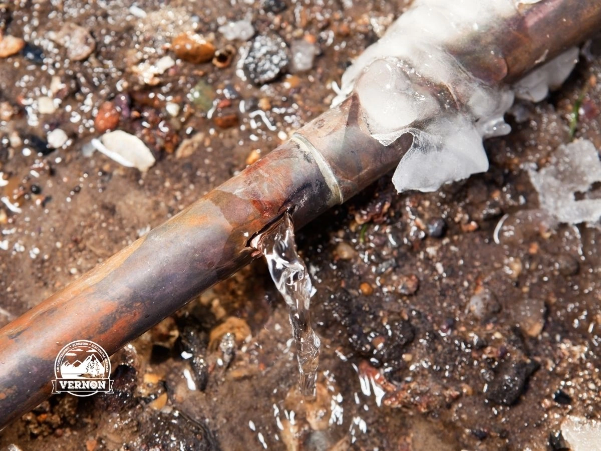 Frozen pipe with water leaking through crack